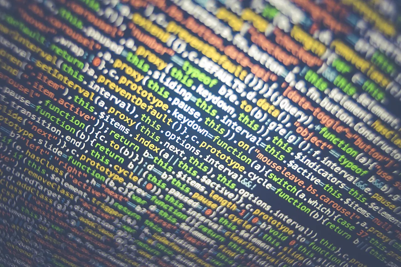 Colourful code on a screen, out of focus